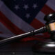 Judge gavel with American flag background