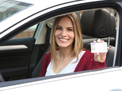 woman shows her drivers license