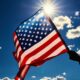 American flag waving against a sunny blue sky - Law Offices of Miguel Martinez, P.C.